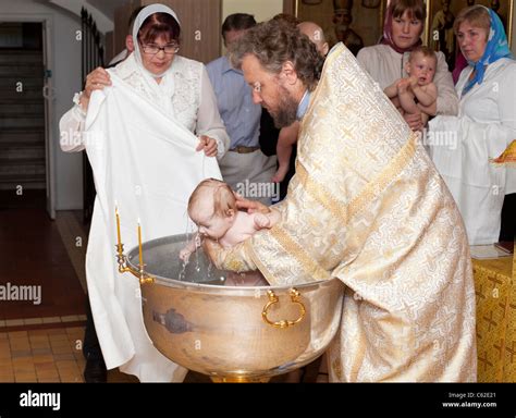 Baby baptism in Russian orthodox church. Priest christening the little ...