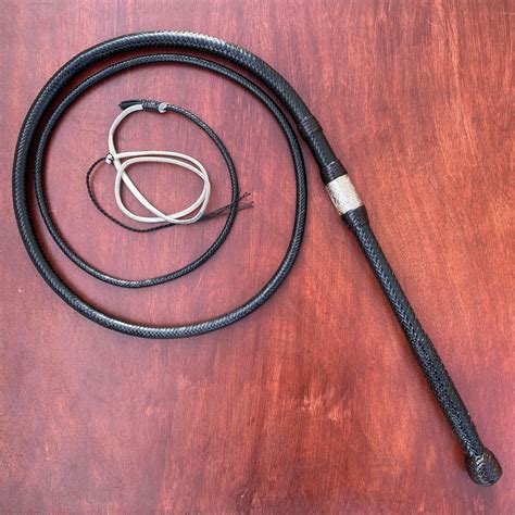 A 6 1/2 foot 16 plait Tachi model bull whip in black with brandy ...