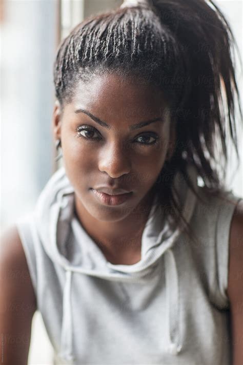 "Portrait Of Young Black Woman" by Stocksy Contributor "Mosuno" - Stocksy