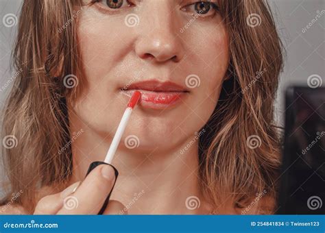 Woman Uses Lipstick, Applies it To Her Lips Stock Photo - Image of glamour, girl: 254841834