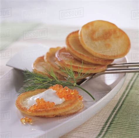 Blinis with sour cream and caviar - Stock Photo - Dissolve