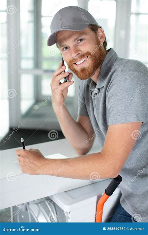 Happy mover man on phone stock photo. Image of delivery - 258549762