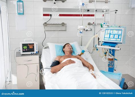 Patient Lying in Hospital Bed Surrounded by Medical Equipment Stock ...