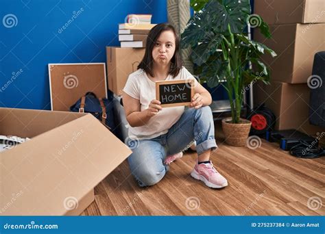 Hispanic Girl with Down Syndrome Sitting on the Floor at New Home ...
