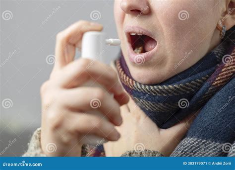 A Woman with a Sore Throat Sprays Medicine Aerosol Spray Down Her ...