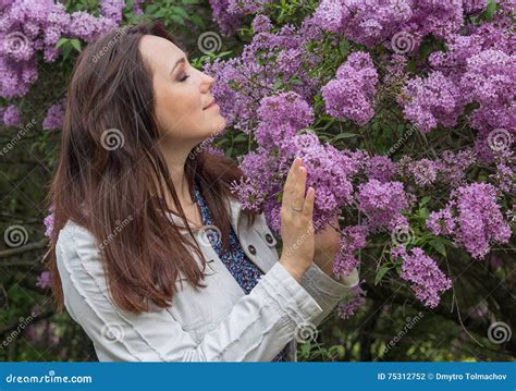 Beautiful Woman in Garden among the Lilacs Stock Photo - Image of ...