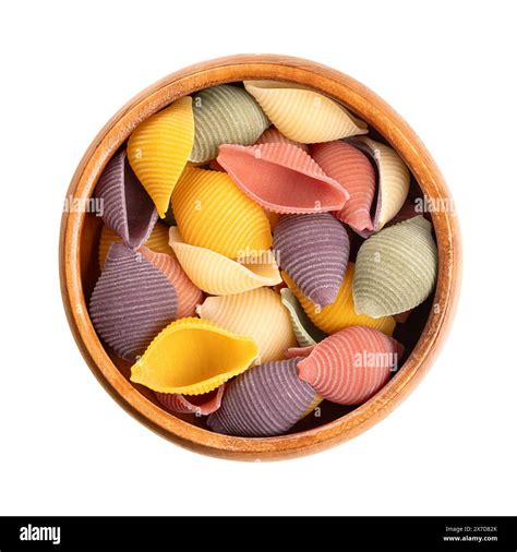 Five-color conchiglie, Italian pasta in a wooden bowl. Round, shell ...