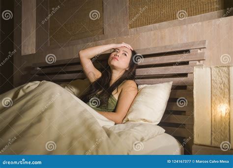 Young Beautiful Depressed and Sad Asian Chinese Woman Having Insomnia Lying in Bed at Night ...