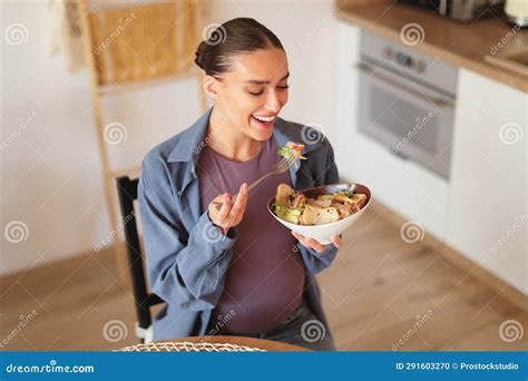 Happy Caucasian Pregnant Woman Eating Caesar Salad, Holding Bowl and ...