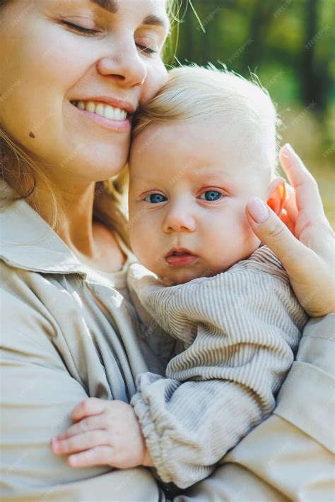 Premium Photo | Happy young mother hug her little son in the sun on a ...