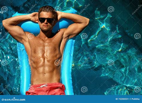 Man Summer Fashion. Male Model Tanning by Pool. Skin Tan Stock Image ...