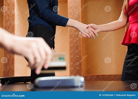 Hand Swiping Debit Card on Pos Terminal. Business People in Office ...