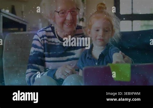 Grandma guiding granddaughter tapping purple tablet green-tab, sparking education overlay, teaching. Grandparent, senior, family, livingroom, daylight, natural, comfort Stock Video Footage - Alamy