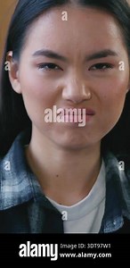 young asian man coughing and sneezes close up