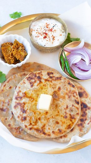 loo Paratha is a special North Indian layered flatbread stuffed with spiced mashed potatoes. The parathas are roasted on the hot griddle until crisp and brown on the outside. Serve them with pickle and yogurt for an authentic Punjabi breakfast. Here is my mom’s recipe to make the best aloo parathas. Get the recipe at pipingpotcurry.com or DM me for the direct #indiancuisine #reelitfeelit #reelkarofeelkaro #reelrecipe #recipevideos #alooparatharecipe #easyrecipes #indianfood | Piping Pot Curry
