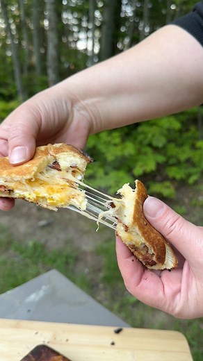 Cooking breakfast pudgie pies over the campfire (and on the camp stove). This is such a fun twist on the usual breakfast sandwich when you’re camping! #outdoorcooking #CampfireCooking #campingfood #pudgiepie | Forest Auntie