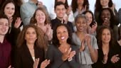 A huge group of multi ethnic people of all ages are clapping and...