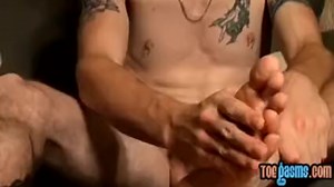 Inked jock Glock shows off feet and wanks for cumshot