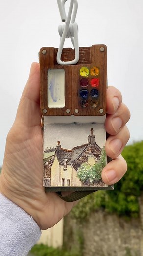 A shelter in the storm🤍 . . . . . . . #watercolorpainting #watercolour #pleinairpainting #pleinair #urbansketching #urbansketch #paintingintherain #rainypainting #lineandwashwatercolor #lineandwash #tinypainting #tinysketchbook #asmr #rain #rainyday #shihtzu #englishtown #englishvillage #englishvillagepainting #artistsofinstagram #lesliestrozart | Leslie Stroz Art