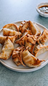 If you love to cook your dumplings with almost zero supervision and a satisfying crunch, you can cook them in an air fryer! But don’t just toss them into the air fryer naked. And the conventional wisdom of brushing them with oil and then air frying at various temperatures until crispy wasn’t quite right either. Both of these methods bothered us because all of the results seemed rather…dry. When it comes to air frying, you can sometimes not only overcook your food, but really dry it out. Such was