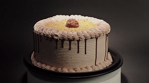 Ferrero rocher cake delicious tasty treat chocolate hazelnut in a turn table loop black background | Premium Stock Video Footage
