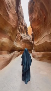 3.5K views · 58 reactions | Walking through the ancient Siq of Petra, a journey through time unfolds with each step. Surrounded by towering rose-red cliffs, she follows the path carved by history, leading to the awe-inspiring Treasury – a hidden world waiting to be discovered. #petra #jordan #visitpetra #shareyourjordan❤️ #shareyourjordan #visitjordan #worldheritage #unesco #worldwonders #trending | Visit Petra | Facebook