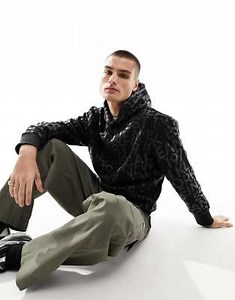 Calvin Klein Relaxed All-Over Logo Hoodie in black | ASOS