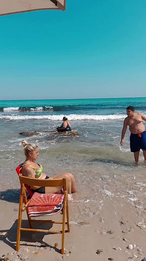 Relaxing Beach Scene with Swimmers and Sunbathers