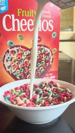 Pouring milk over Fruity Cheerios cereal