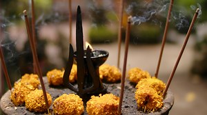 aromatic incense on an altar in a Hindu temple amidst flowers