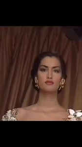 Christian Dior shows its women's 1991 spring-summer haute couture line in Paris. Model Yasmeen Ghauri is wearing an evening gown with a plunging neckline and full, pleated skirt. | Runwaymodel