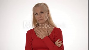 Portrait of unhappy mature woman with an MCOT heart sensor on her chest, demonstrating the importance of monitoring atrial fibrillation and maintaining health.