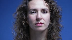 Woman nodding yes in affirmation giving thumbs up, tight close-up of person face