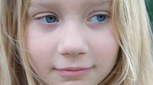 clip-1107372925-video-portrait-blond-child-looking-camera-laughing