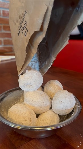 Save room for dessert! Indulge in our irresistible Zeppole! These fluffy Italian doughnuts are fried to perfection and dusted with plenty of powdered sugar. | Bocca Lupo Coal Fired Pizza