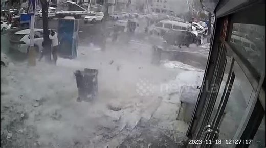 Chinese man shields girlfriend from dangerous snow chunks falling off building roof