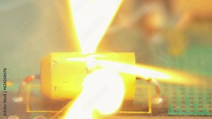 Tantalum capacitor explodes in slow motion. Computer virus consequences. System failure metaphor. System overload concept. Sparks fire non condenser background 4K.