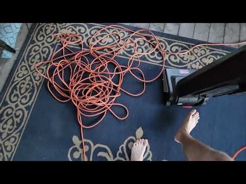 Rubbermaid commercial vacuum cleaning a dirty sunroom.