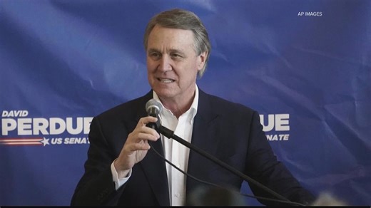 David Perdue shakes hands in campaign ad with ex-Georgia deputy arrested on child pornography charges