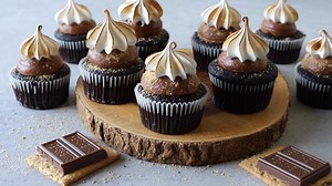Let’s make S’mores Cupcakes today! They are Chocolate Cupcakes, filled with Milk Chocolate Ganache, topped with a Milk Chocolate Buttercream, coated in graham cracker crumbs, and topped with Marshmallow Frosting. https://www.piesandtacos.com/smores-cupcakes/ | Pies and Tacos