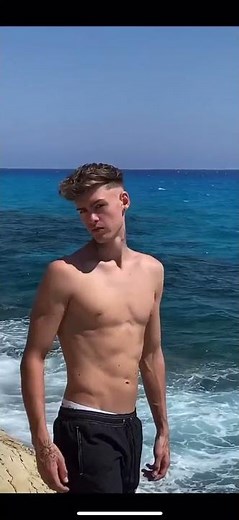 Shirtless Boy Walking At Beach
