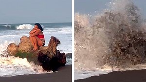 Woman sets up contemplative scene on beach, eats a massive wave