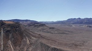 Wide panning aerial shot of the alien desert landscape near Death Valley National Park, California. 4K