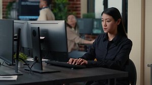 Woman Software Developer Typing Code in Modern Office