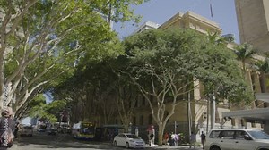 Tilt pan from Brisbane City Hall in King eorge Square to Adelaide Street with Buses.