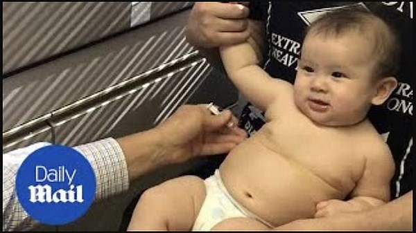 Doctor soothes baby during vaccination with playful song