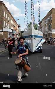 London, UK. 22 June, 2023. A model of the Empire Windrush leads the Windrush Procession through Brixton to Windrush Square marking the 75th anniversary of the arrival of immigrants from the Caribbean at the Port of Tilbury aboard the vessel. The celebration was described by many as "bittersweet" in the wake of a scandal which saw many arrivals and their descendants wrongly threatened with deportation or detention by the Home Office. Credit: Ron Fassbender/Alamy Live News Stock Photo - Alamy