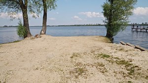 Sandy Beach at lake Jezioro Duże Żnińskie in Żnin, Poland | Premium Stock Video Footage