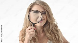 Alluring blonde using the magnifer