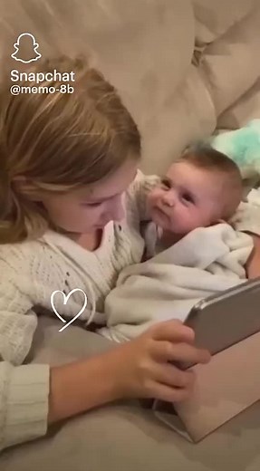 Adorable Moment: Girl and Baby Enjoying Tablet Together